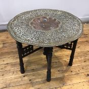 An Indian brass low tray table, Jaipur, early 20th century, the large tray in relief with a dense