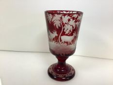 A 19th century Bohemian ruby flash glass goblet, the bowl wheel-engraved with deer in a wooded