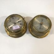 A brass bulkhead clock and a brass bulkhead barometer, of characteristic form, each with silvered