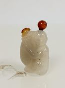 A fine Chinese carved white and russet jade snuff bottle, modelled as a boy with cheerful expression