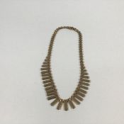 A gold fringe necklace, probably 9ct (marks indistinct), of graduated rectangular links. Length