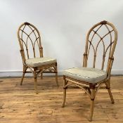 A pair of modern bamboo hall chairs of Gothic design, each with arched back of interwoven spars,