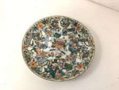 An unusually decorated Chinese porcelain plate, probably late 18th century, the well centred by a