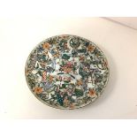 An unusually decorated Chinese porcelain plate, probably late 18th century, the well centred by a