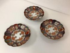 A set of three Chinese Imari palette porcelain dishes, of circular scalloped form, decorated with