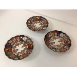 A set of three Chinese Imari palette porcelain dishes, of circular scalloped form, decorated with