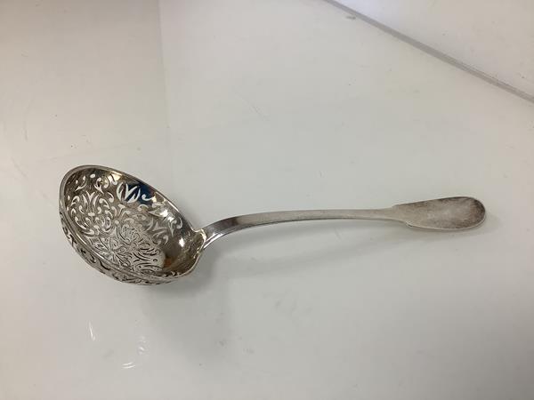 A French silver sifting ladle, c. 1800, Paris marks, 950 standard, with fiddle terminal and