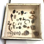 A small collection of excavated Pictish or Celtic artefacts including buckles, clasp, ceramic