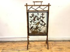 A Victorian taxidermy display of exotic birds, mounted in a glazed and ebonised case, supported on a