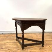 A late 17th century oak credence-style table, the semi-elliptical top with iron fixings above a