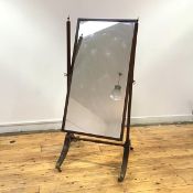 A Regency style mahogany cheval mirror, early 20th century, the rectangular plate within a pair of