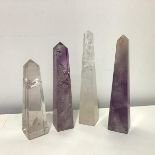 A group of four carved table obelisks: two in rock crystal, two in amethyst. (4) Tallest 20.5cm