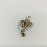 An Edwardian 9ct gold, amethyst and seed pearl brooch/pendant, millegrain set with two oval-cut