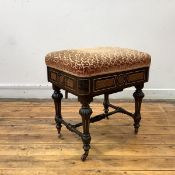 A late 19th century ebonised adjustable piano stool, the padded seat with cut-velvet upholstery,