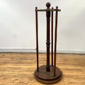 A 19th century mahogany cue stand, with central turned support and ball finial, with brass sprung