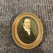 English School, c. 1820, a portrait miniature of a gentleman in high white collar and stock,