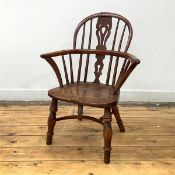 A 19th century child's Windsor-type armchair, in elm and yew wood, the hoop back with pierced splat,