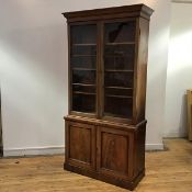 A George IV mahogany bookcase, of good proportions, the projecting cornice above a pair of