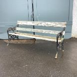 A Victorian cast iron garden bench, the pierced ends with scroll detailing enclosing a painted