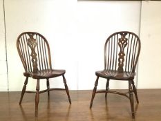 A set of nine oak hoop back dining chairs, the moulded arched backs with turned spindles and