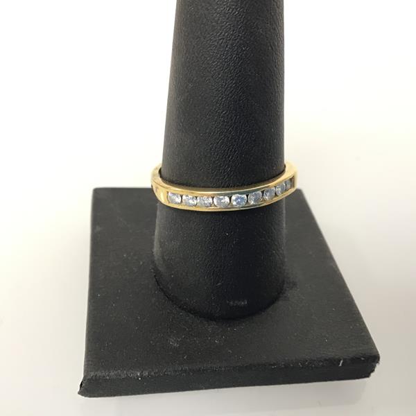 A yellow metal channel set half eternity ring, with brilliant cut diamonds (2.64g) (S)