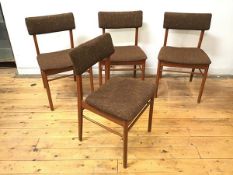 A set of four 1970s dining chairs, the tablet backs with upholstered padding, on matching seats,