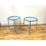 An Ikea pair of Gladon tables, each with detachable tray and raised gallery, on rod supports (h.52cm