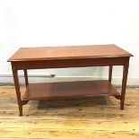 A Stag coffee table, the rectangular top with moulded edges, fitted two drawers to each side, over a