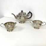 A 1930 Birmingham silver three piece tea service comprising teapot (h.16cm x 26cm) (238.48g), with