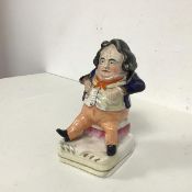 A 19thc Staffordshire Fat Man figure (h.14cm x 9cm x 7cm)