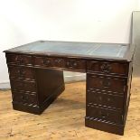 A reproduction mahogany pedestal desk, the rectangular top with moulded edge and tooled leather
