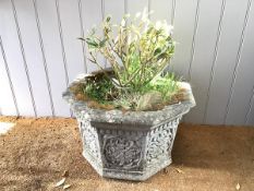 An octagonal composition stone planter, with moulded frieze, each panel with beaded decoration and a