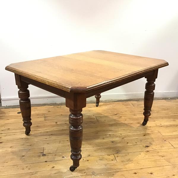 A late 19thc mahogany telescopic dining table, the rectangular top with moulded edge and canted