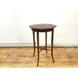 An Edwardian mahogany and boxwood lined occasional table, the shaped top with moulded edge raised on