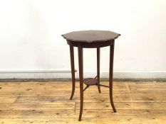 An Edwardian mahogany and boxwood lined occasional table, the shaped top with moulded edge raised on