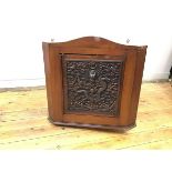 An intricately carved Chinese hardwood panel depicting a dragon emerging from the sea against a