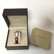 A Burberry lady's quartz stainless steel watch with mother of pearl dial on red leather strap,