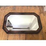 A 1920s/30s oak framed mirror, the octagonal bevelled glass within an oak frame, with beaded edge (