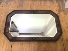 A 1920s/30s oak framed mirror, the octagonal bevelled glass within an oak frame, with beaded edge (