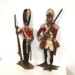 A pair cast metal military wall appliques in the form of British Soldiers in polychrome uniform (h.