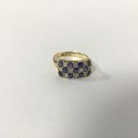 An 18ct gold sapphire and diamond chequerboard style ring mounted in claw setting (O/P) (3.48g)