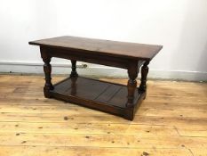 An oak occasional table, apparently made from old railway sleepers, the rectangular plank top raised