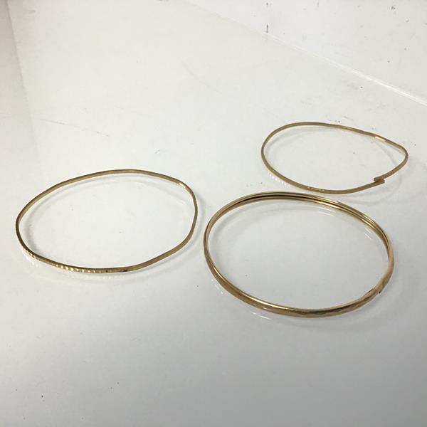 A 9ct gold textured stiff bangle (repairs) and two other 9ct gold textured bangles (one a/f) (