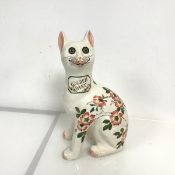 A Griselda Hill pottery Wemyss Galle style cat, decorated with briar rose design, signed verso (h.