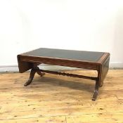 A reproduction mahogany coffee table in the form of a Regency sofa table, the rectangular top with