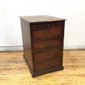 A filing cabinet in the Georgian style, the rectangular top with a central tooled leather panel,