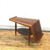 An unusual 1950s mahogany occasional table, the tapering top incorporating a bookrest, raised on