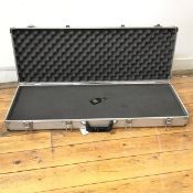 A gun case, the hinged top closed by four lockable clasps, interior with foam, complete with keys (