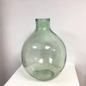 A large glass carboy of light green glass with large aperture to top (h.60cm x d. 45cm (approx))