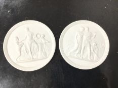 A pair of Royal Copenhagen white basalt plaques, each depicting a classical scene within a foliate